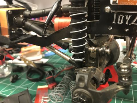 1989 Ford Bronco - Detail of an RC car's suspension system, showing a coilover shock absorber and various linkages.