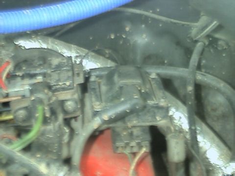 1989 Ford Bronco - Close-up view of engine components, including a distributor cap and wiring harness.