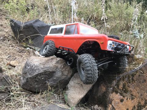 1989 Ford Bronco - This remote-controlled vehicle is designed to look like a classic SUV, navigating a rocky terrain.