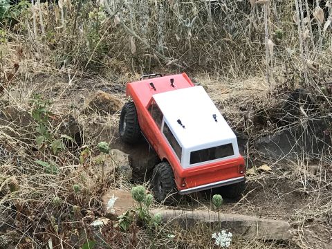 1989 Ford Bronco - A toy RC truck navigates a rocky path.