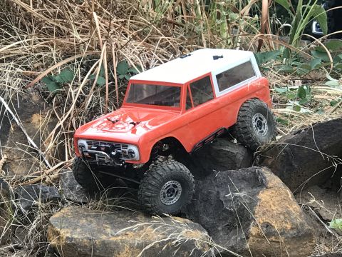 1989 Ford Bronco - This RC rock crawler, resembling a 1966 Ford Bronco, navigates a rocky terrain.