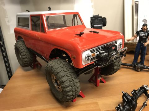 1989 Ford Bronco - RC Bronco body, likely a 1966 model, is mounted on red jack stands with a winch attached to the front bumper.