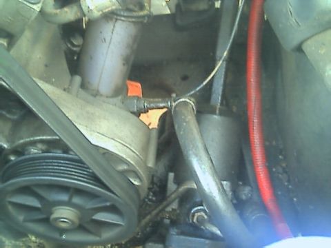 1989 Ford Bronco - This image shows a close-up view of engine components, including a pulley and belt system.
