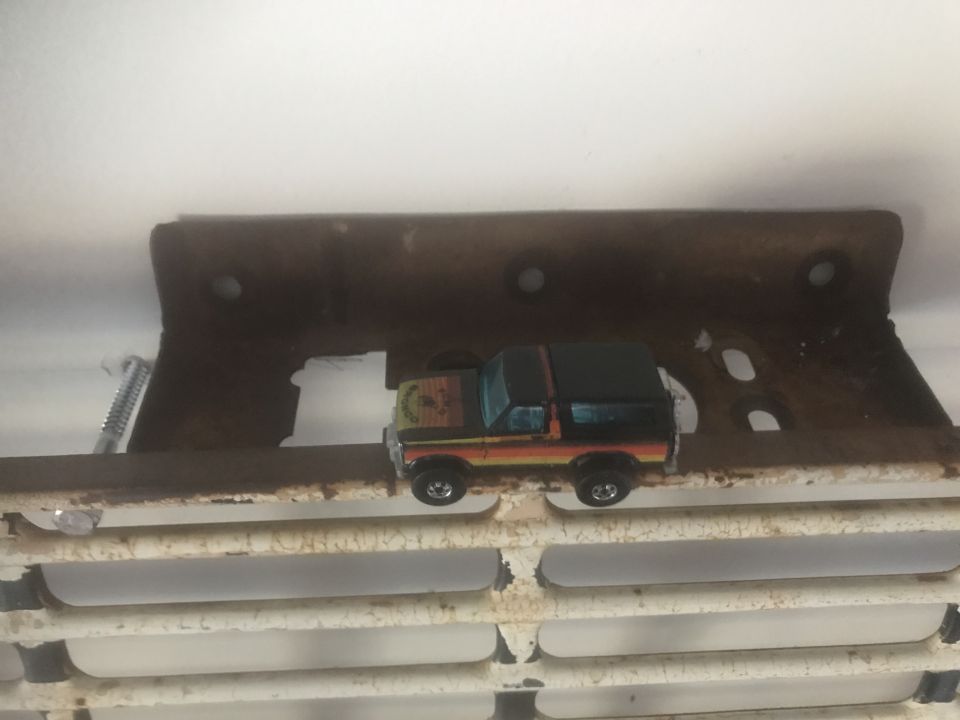 Toy Bronco with orange, yellow, and green stripes on its side