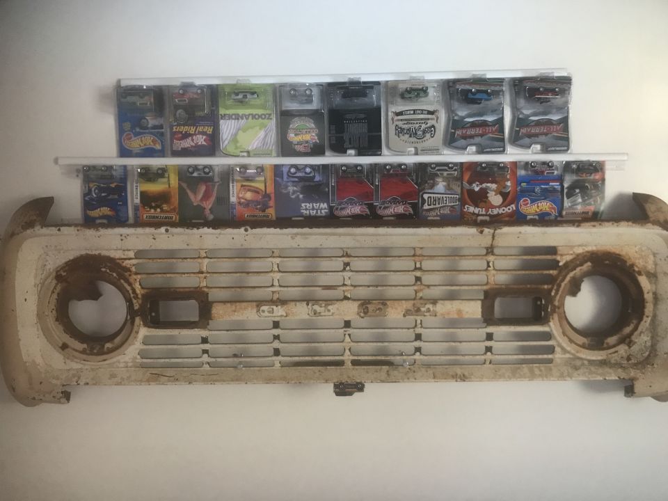 1974 Ford Bronco grille with toy cars above