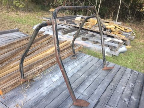 1994 Ford Bronco - This appears to be a roll cage, not a 1994 Ford Bronco. The item is rusty and sits on a weathered wooden deck.