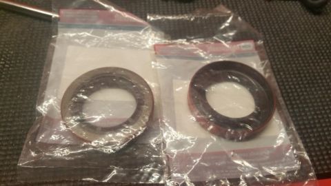 1996 Ford Bronco - These are two new oil seals, likely for a vehicle, shown in their packaging.