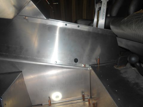 1992 Ford Bronco - The interior of the vehicle shows custom metal fabrication work around the seats and floor.