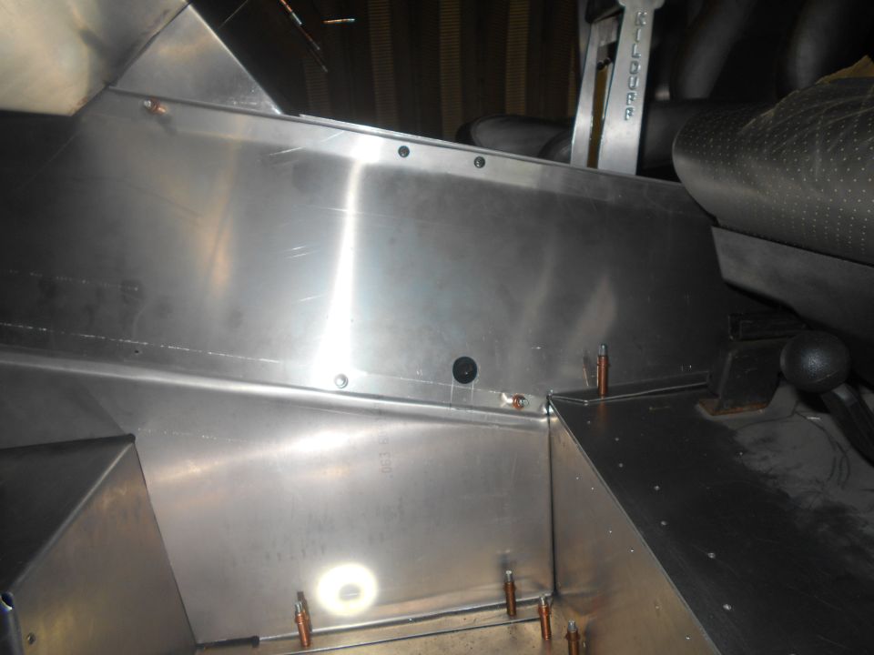 Interior view of custom metal panels and seats in a vehicle