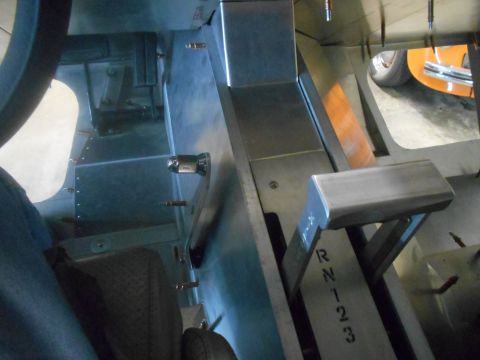 1992 Ford Bronco - Interior view of a vehicle's floor shifter console, with a partial view of another vehicle in the background.