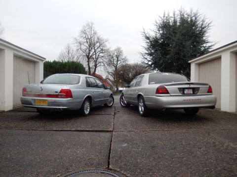 1999 Ford Fairlane - Two silver sedans are parked in a driveway, one clearly marked as a Marauder.