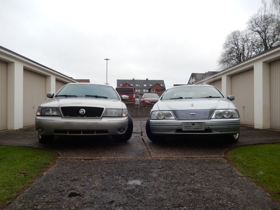 Mercury Grand Marquis next to a Ford Falcon, both facing forward