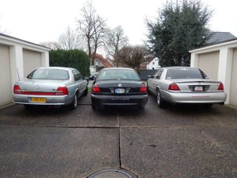1999 Ford Fairlane - Three sedans, including two Mercury Marauders, are parked in a driveway.