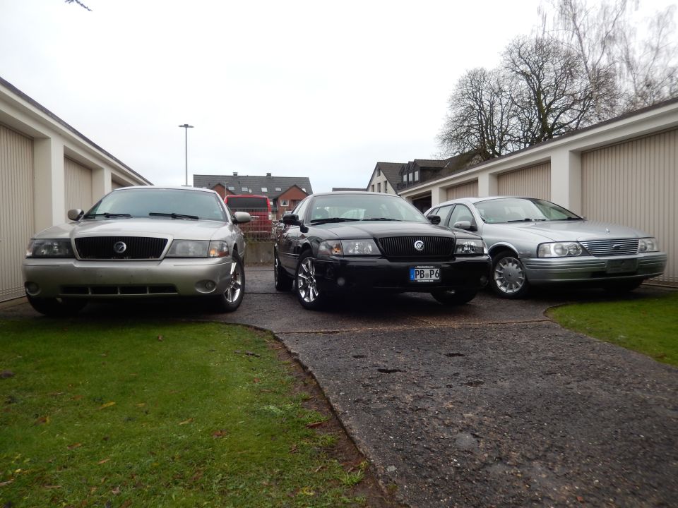 Silver 2003 Mercury Grand Marquis front view, parked next to two other sedans