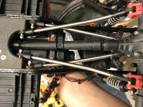 1989 Ford Bronco - Close-up view of the suspension and drivetrain of a remote control car chassis.