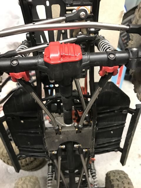 1989 Ford Bronco - The underside of a remote control car chassis is visible, showing its suspension and drivetrain components.