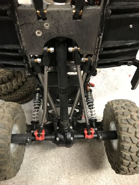 1989 Ford Bronco - Undercarriage view of a remote control car chassis, highlighting the suspension components and large off-road tires.