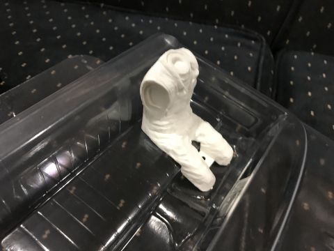 1989 Ford Bronco - A white plastic model part is presented in clear packaging against a dark, patterned background.