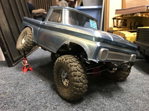1989 Ford Bronco - RC pickup truck body on a custom chassis, front passenger wheel elevated on a jack stand.