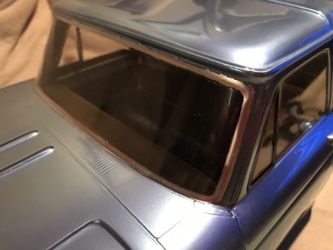 1989 Ford Bronco - Close-up view of the interior of a blue pickup truck, focusing on the windshield and dashboard area.