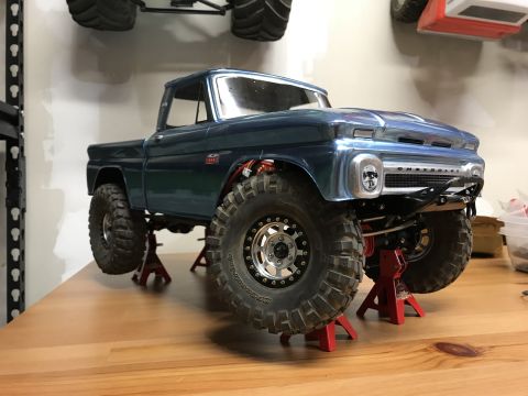 1989 Ford Bronco - This blue 1966 Chevrolet C10 pickup truck is displayed on red jack stands, its front end and lifted suspension.