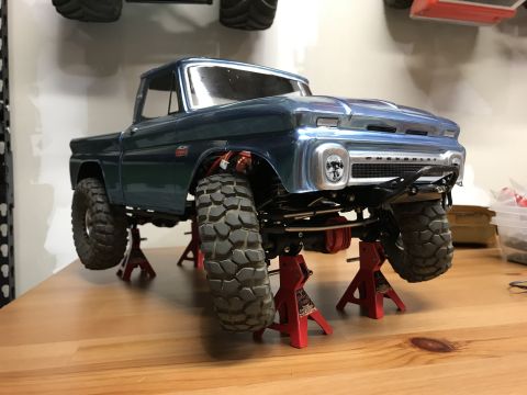 1989 Ford Bronco - Model truck on jack stands, appears to be a 1966 Chevrolet C10 based on grille detail.