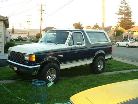 1990 Ford Bronco - This 1990 Ford Bronco is parked on a grassy lawn in front of a house.