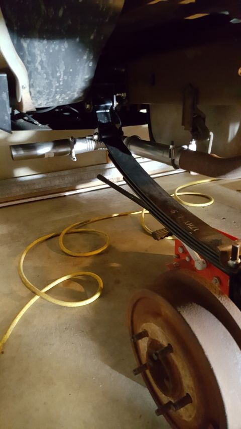 1996 Ford Bronco - Close-up of a vehicle's leaf spring and exhaust system components.