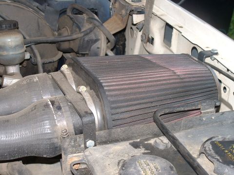 1990 Ford Bronco - Close-up of an aftermarket air filter assembly in a vehicle's engine bay.