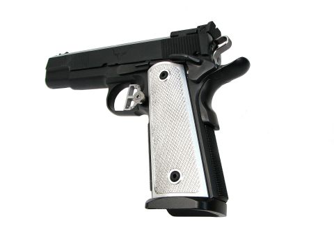 1996 Ford Bronco - Close-up of a semi-automatic pistol, likely a 1911 variant, against a white background.