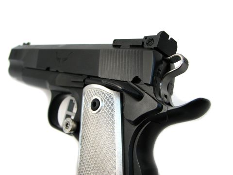 1996 Ford Bronco - A detailed view of a handgun, focusing on its grip and slide details.