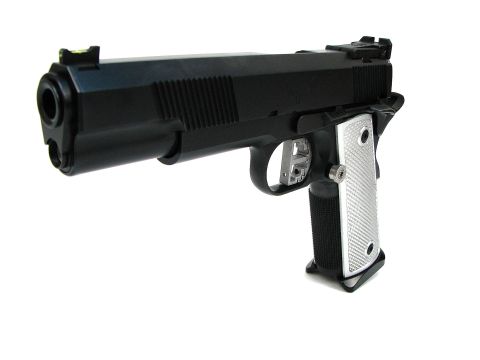 1996 Ford Bronco - A black handgun with silver checkered grips is shown from a front-left perspective against a white background.