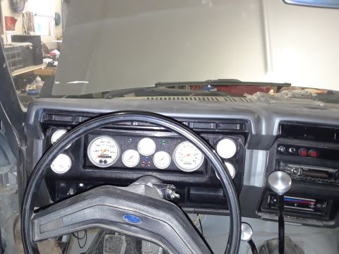 1985 Ford Bronco - The interior of a 1985 Ford Bronco showcases a dashboard fitted with aftermarket gauges.