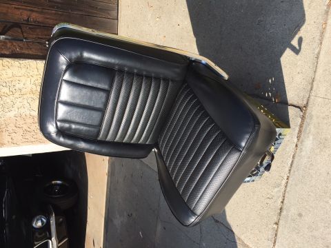 1967 Ford Fairlane - A black vinyl car seat with distinctive stitching patterns is shown, detached from a vehicle.