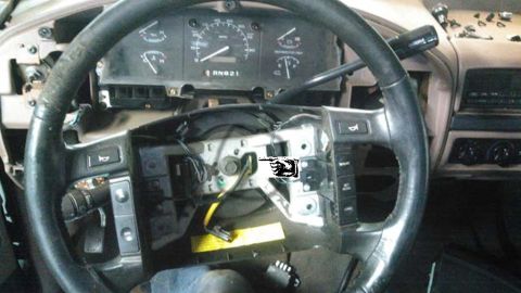1900 Ford Bronco - The dashboard of a vehicle is shown with the steering wheel and instrument cluster partially disassembled.