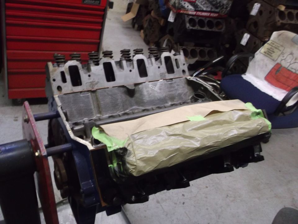 Engine block on stand, covered with paper and tape