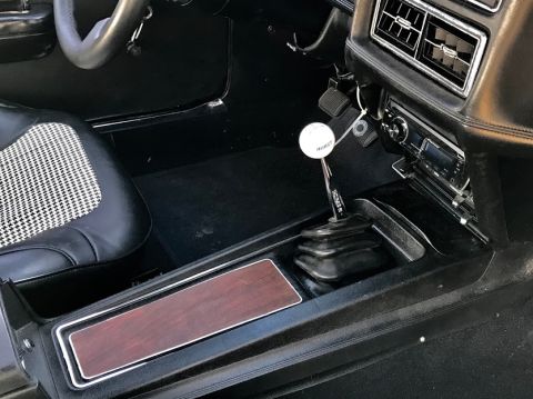 1969 Mercury Cougar - The interior features a Hurst shifter and woodgrain trim on the center console.