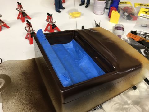 1989 Ford Bronco - Model car body is being prepped for paint with blue masking tape inside.