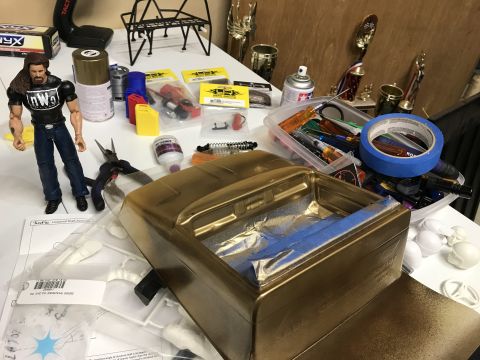1989 Ford Bronco - Model car parts and tools are laid out on a table, suggesting a hobbyist's workspace.