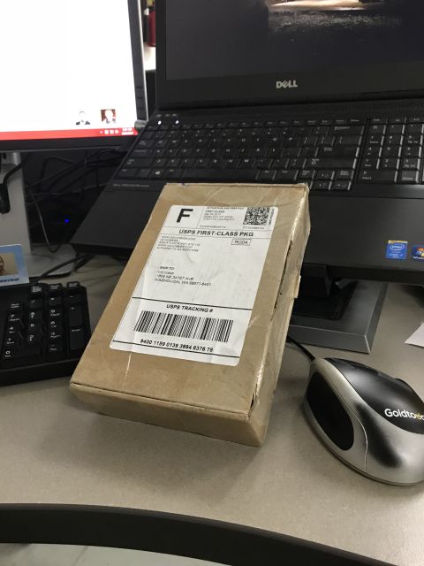 1989 Ford Bronco - A package sits on a desk, ready for shipment via USPS First-Class Package Service.