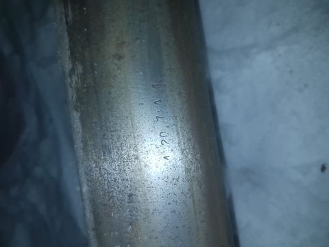 1995 Ford F-150 - Close-up of a metal axle component showing stamped identification numbers.