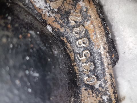 1995 Ford F-150 - A close-up view shows a part with stamped numbers, possibly a casting or serial number.