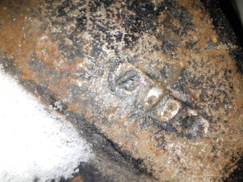 1995 Ford F-150 - This heavily corroded metal part shows significant rust and grime, obscuring any identifying details.