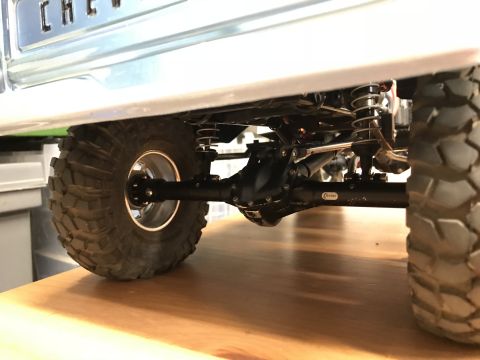 1989 Ford Bronco - The detailed undercarriage of a remote-controlled vehicle is shown, highlighting its suspension and drivetrain components.