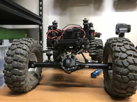 1989 Ford Bronco - The rear axle and suspension of an RC car are shown in detail, with large off-road tires.