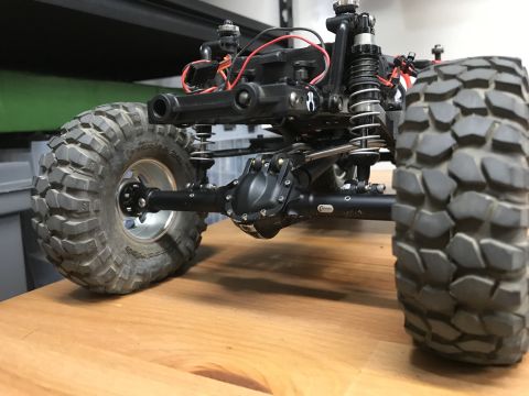 1989 Ford Bronco - Detail shot of a remote-controlled car's heavy-duty axle and suspension system.