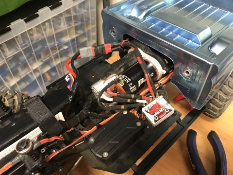 1989 Ford Bronco - Close-up view of the internal components and wiring of a remote-controlled vehicle chassis.