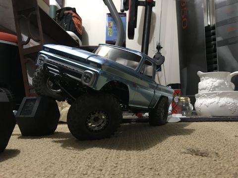 1989 Ford Bronco - A blue toy truck is positioned on carpet with large off-road tires.