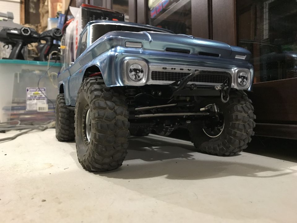 Blue RC rock crawler truck with large tires, front view