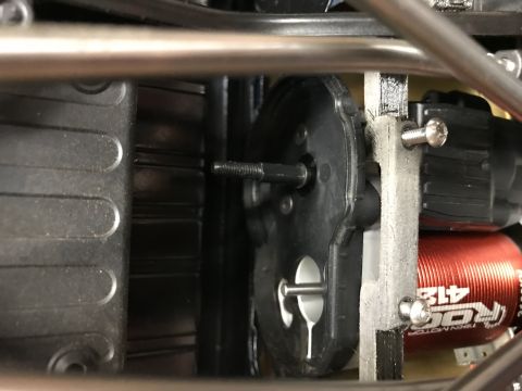 1989 Ford Bronco - Detail of a red RC motor and black gearbox assembly, showing mechanical components.